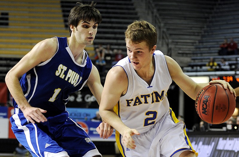 Fatima guard Patrick Schnieders looks for an opening into the lane while being guarded by St. Pius X guard McKinley Mason in the second half of Thursday's Class 3 semifinal game at Mizzou Arena.