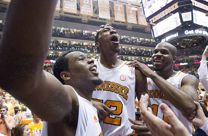 Tennessee forward Kenny Hall (20), guard Jordan McRae (52) and guard Trae Golden (11), left to right, celebrate the Vols' 64-60 win over Missouri in an NCAA college basketball game at Thompson-Boling Arena Saturday, March 9, 2013, in Knoxville, Tenn.