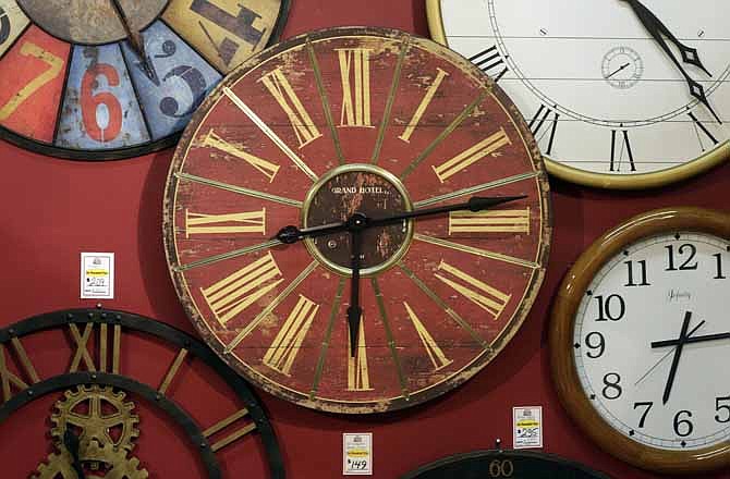 Clocks hang on a wall in Hands of Time, a clock store and repair shop in Savage, Md., Friday, March 8, 2013. 