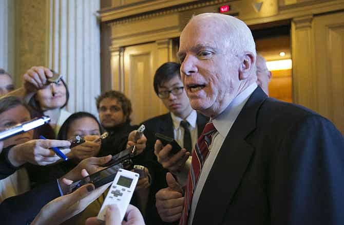 In this March 7, 2013, file photo Sen. John McCain, R-Ariz. speaks with reporters on Capitol Hill in Washington after a GOP policy meeting. McCain was one of a small group of Republican senators who dined with President Barack Obama the previous night to address political gridlock. McCain is one of a bipartisan group of eight senators, nicknamed the "Gang of Eight", who meet in private several times a week to to come to terms with the overhaul of the nation's byzantine immigration laws.