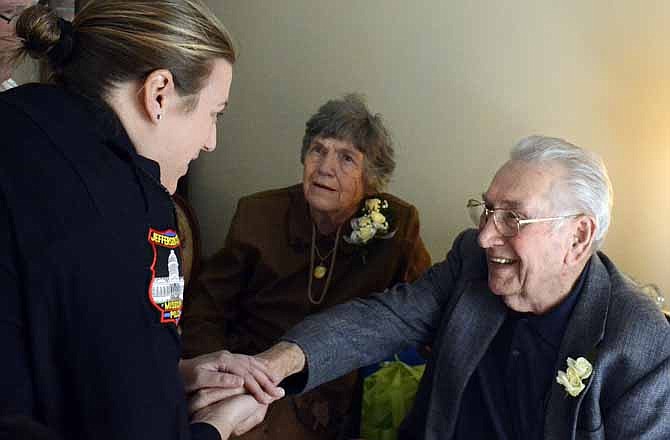 Rudy, right, and Dorothy Lemke, center, were surprised to find out that Jefferson City Police Officer Meredith Friedman, left, was the person who had rescued them when their house caught on fire in October 2011.