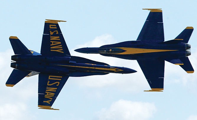 Two U.S. Navy Blue Angels execute a crossing maneuver at close range during the Miramar Air Show in San Diego. Deep budget cuts in Washington mean military flight teams are expected to be no-shows at air shows across the U.S. starting this spring, leaving dozens of host cities bracing for thinner crowds and lost tourism dollars. 
