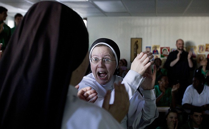 Sister Martin Therese, center, of St. Mary's High School in Phoenix, cheers with sisters and their teachers while they watch a live telecast Wednesday of the announcement of Pope Francis.