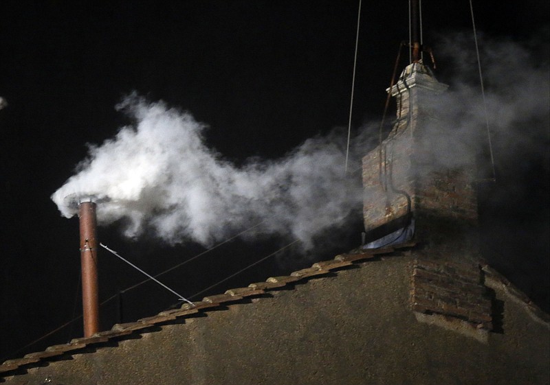 White smoke emerges from the chimney on the roof of the Sistine Chapel, in St. Peter's Square at the Vatican, Wednesday, March 13, 2013. The white smoke indicates that the new pope has been elected.