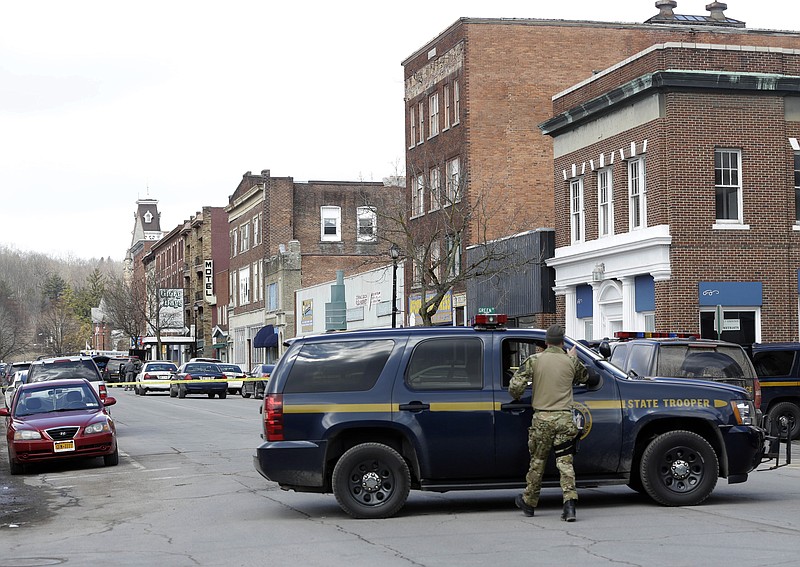 Law enforcement officers block off Main Street in Herkimer, N.Y. on Wednesday while searching for a suspect in two shootings that killed four and injured at least two.