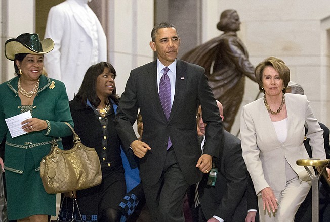 President Barack Obama and House Minority Leader Nancy Pelosi, D-Calif., leave a meeting with House Democrats at the Capitol on Thursday. At far left is Rep. Frederica Wilson, D-Fla., with Rep. Terri Sewell, D-Ala., second from left.