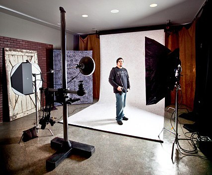 Craig Chapman poses in his photography studio, Cx3 Photography. Chapman is producing a photo album documenting the historic architecture of many of the Fulton State Hospital buildings and structures that now lie in disrepair. Chapman's project comes before a pending bond issue that would demolish many of these buildings and pave the way for a new updated facility.