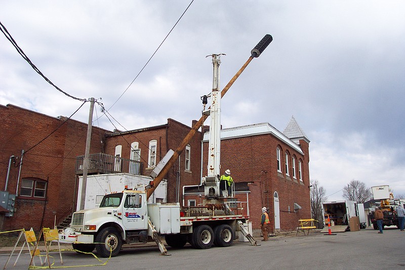 The old analog emergency siren and pole behind the Russellville City Hall were replaced Thursday morning with a new digital siren and a taller pole. The solar-powered equipment should send the emergency signal further and clearer. The installation was part of a county-wide effort. Democrat staff/Michelle Brooks