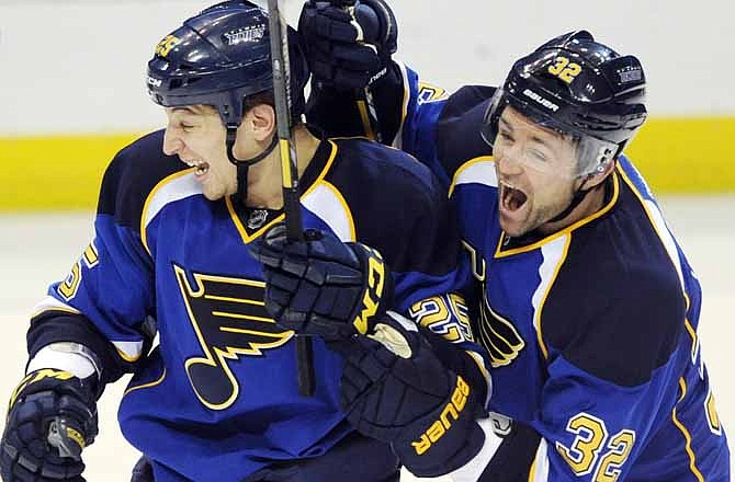 St. Louis Blues' Chris Stewart (25) celebrates the winning goal in overtime with Chris Porter (32) against the Anaheim Ducks in an NHL hockey game, Saturday, March 16, 2013, in St. Louis. The Blues won 2-1.