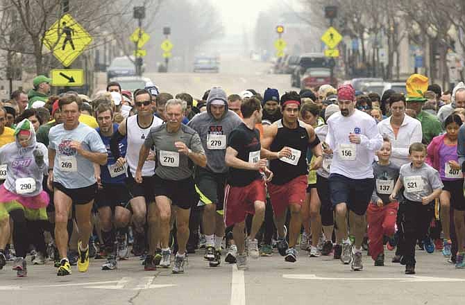 Varied and colorful participants in the YMCA's Luck of the Irish 5K run take off. The race was held in downtown Jefferson City on Saturday.