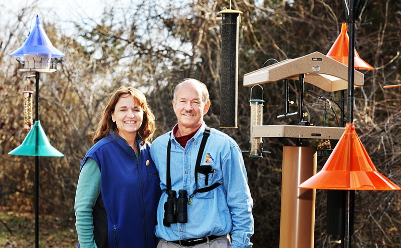 Steve and Regina Garr stand among their birdhouses at Birds-I-View.