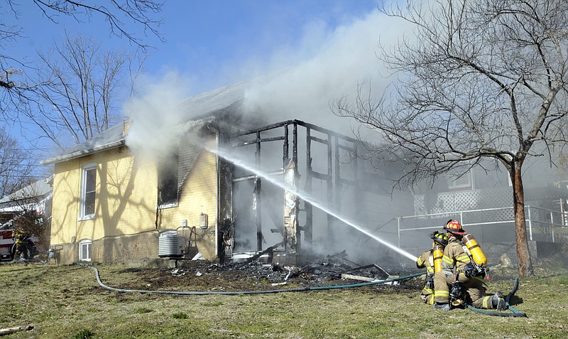 Firefighters battled a house fire at the corner of Hough and McKinley streets for more than an hour Monday afternoon. The family was able to escape safely, but Latrisha Jones and her family will be unable to salvage much of anything, let alone return to live there. The children got out with the clothes they were wearing, and neighbors quickly pitched in to find coats and shoes for them. The Heart of Missouri American Red Cross arrived on the scene to help the family however they could.