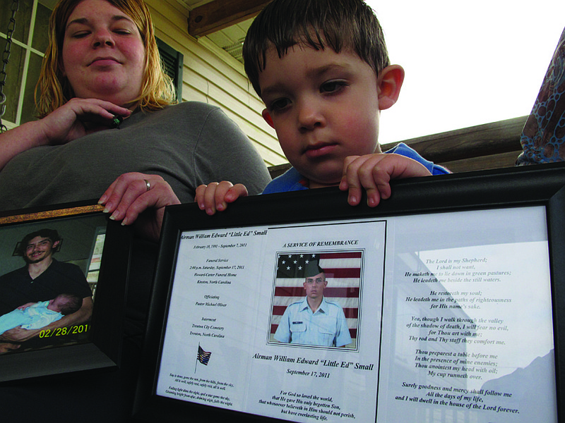 Shane Mercer points to a photo of his father, Airman Will Small, as his mother Alecia Mercer looks on at their Kinston, N.C., home on Monda. Will Small died of rabies, and people who received his donated organs became sick, and one has died. 