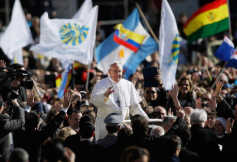 Pope Francis waves to crowds as he arrives for his inauguration Mass in St. Peter's Square at the Vatican, on Tuesday. 