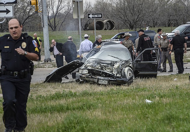 
Emergency personnel work the scene of a crash and shootout with police in Decatur, Texas, involving the driver of a car similar to one wanted in connection with the killing of Tom Clements. The driver led police on a gunfire-filled chase through rural Montague County, crashed his car into a truck in Decatur, opened fire on authorities and was shot, officials said. 