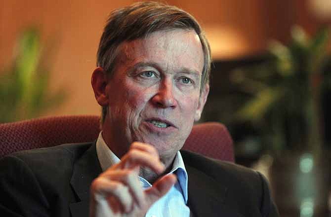In this Dec. 12, 2012 file photo, Colorado Gov. John Hickenlooper is pictured during an interview with the Associated Press at his office in the Capitol in Denver. 
