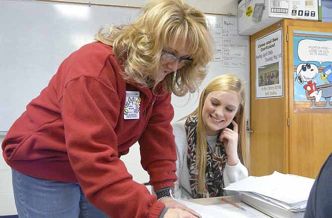 Savannah Babington, a junior at Mountain Home, Ark., High School, receives some one-on-one assistance in teacher Kathy Wham's math class. Wham said allowing students to belong to smaller learning communities "helps our kids have a place to belong" and "gives them a sense of ownership" in their school.