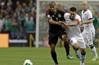 Clint Dempsey of the United States (right) and Carlos Salcido of Mexico vie for control of the ball during Tuesday night's World Cup qualifying match in Mexico City. The match ended scoreless. Mexico is now 68-1-7 in World Cup qualifiers at home.