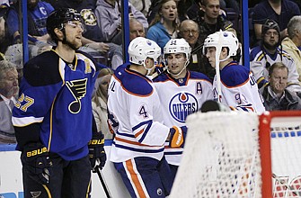 Jordan Eberle (14) of the Oilers celebrates with teammates Taylor Hall (4) and Ryan Nugent-Hopkins (93) after scoring a goal as Alex Pietrangelo of the Blues reacts during Tuesday night's game in St. Louis.