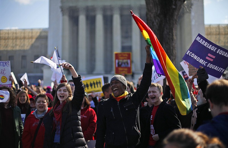 Demonstrators chant Tuesday outside the Supreme Court in Washington, as the court heard arguments on California's voter-approved ban on same-sex marriage, Proposition 8.
