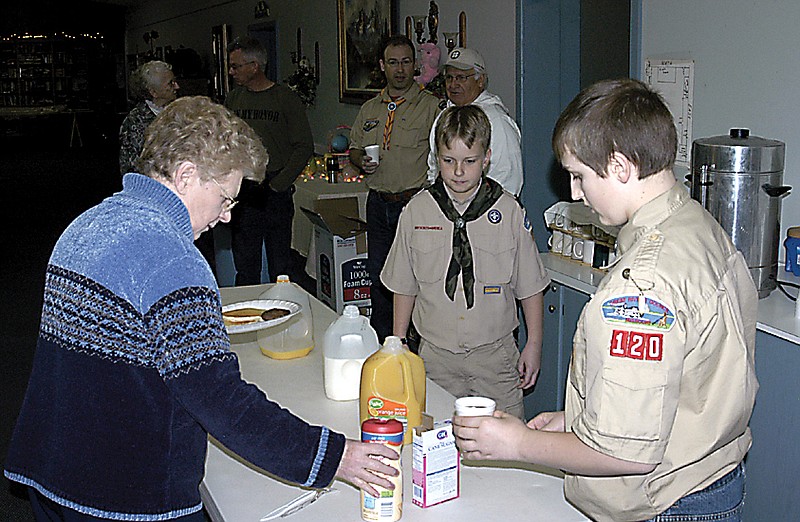 Boy Scouts serve one of the customers saturady at the annual pancake and sausage breakfast. 