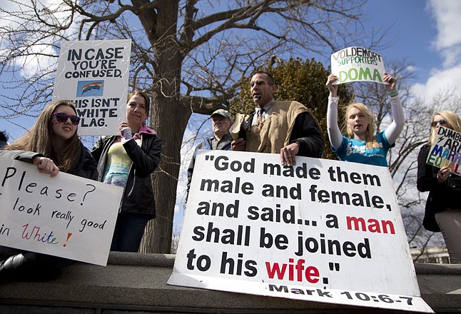 Allan Hoyle of North Carolina, center, speaks out against gay marriage Wednesday amid gay rights supporters across the street from the Supreme Court in Washington, after the court heard arguments on the Defense of Marriage Act (DOMA) case. 