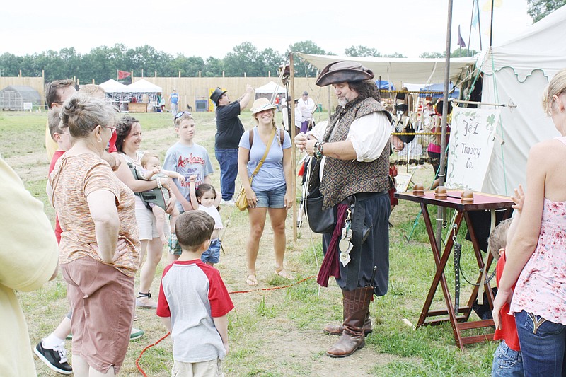 A modern-day pirate shows a magic trick to a crowd at the 2011 Pirate Festival. Now rechristened the Fantasy Fair, the event returns April 27 and 28 to Boster Castle in Kingdom City.