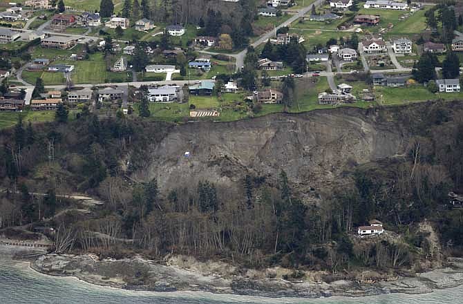 An aerial photo shows a landslide near Coupeville, Wash. on Whidbey Island, Wednesday, March 27, 2013. The slide severely damaged one home and isolated or threatened more than 30 on the island, about 50 miles north of Seattle in Puget Sound. No one was reported injured in the slide, which happened at about 4 a.m. Wednesday. 