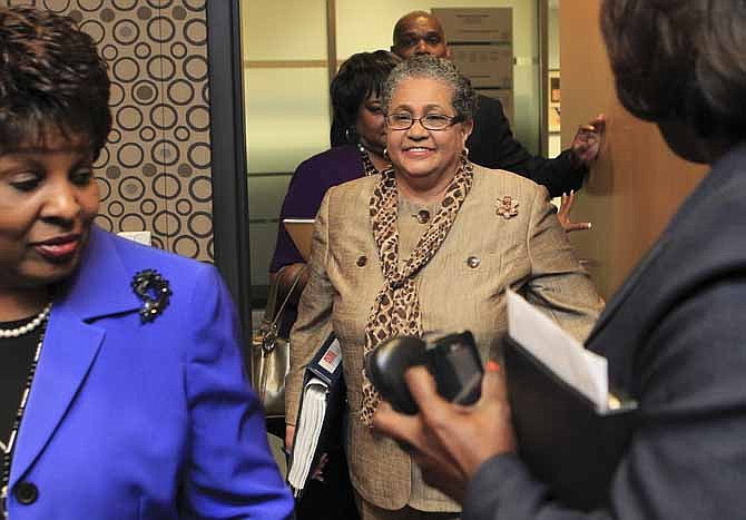 Outgoing schools superintendent, Dr. Beverly Hall, center, arrives for her last Atlanta school board meeting in June 2011 at the Atlanta Public Schools headquarters in Atlanta. Hall and nearly three dozen other administrators, teachers, principals and other educators were indicted Friday, in one of the nation's largest cheating scandals.