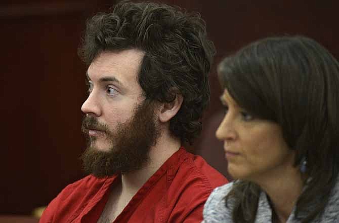 In this March 12, 2013 file photo, James Holmes, left, and defense attorney Tamara Brady appear in district court in Centennial, Colo. for his arraignment.