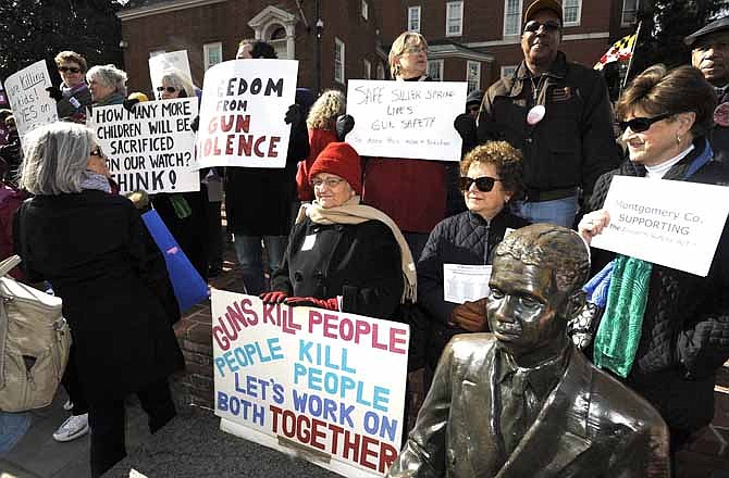 Supporters of the Firearms Safety Act wave their signs protesting against gun violence at the Prevent Gun Violence Rally on Lawyer's Mall in front of the Maryland State House, Friday, March 1, 2013 in Annapolis. As a gun-control measure aims to ban assault weapons in Maryland, neighboring states are trying to woo away a Beretta factory, whose employees would be unable to buy some of its products. 