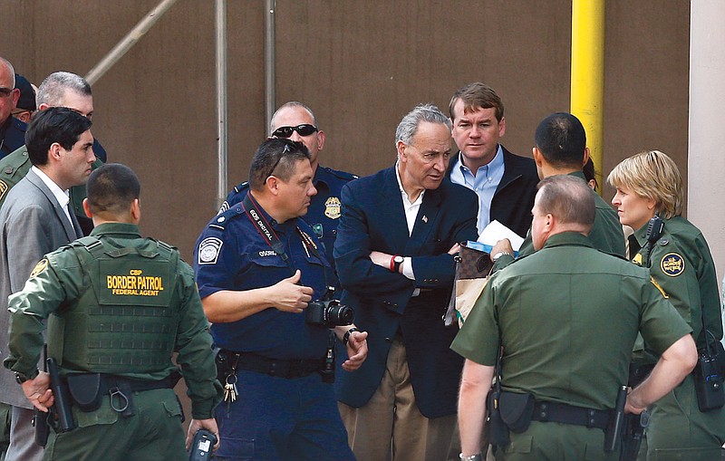 Sen. Chuck Schumer, D-NY, center, and Sen. Michael Bennett, D-Colo., rear, speak with U.S. Border Patrol agents and U.S. Customs and Border Protection agents during their tour of the Mexico border with the United State.