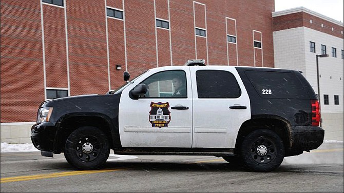 An officer in a Chevy Tahoe pulls out of the Jefferson City Police station on McCarty Street. The Jefferson City Police Department is in the processes of trading out Ford Crown Victorias for Chevrolet Tahoes in a cost-saving measure and so officers have plenty of room for themselves and their gear.