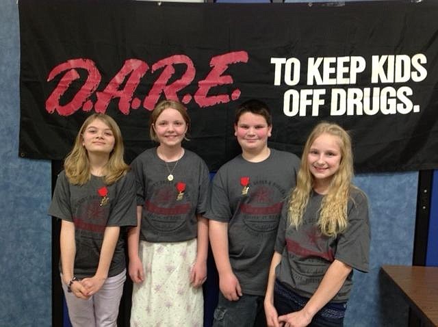 Cole County R-I Schools recognized 40 students who graduated from the D.A.R.E program, led by Cole County Sheriff's Deputy Joe Matherne. Those recognized for exceptional essays include, from left, Alexis Christmann, Megan Rector, Logan Morris and Gabbriella Kaffman. Submitted photo