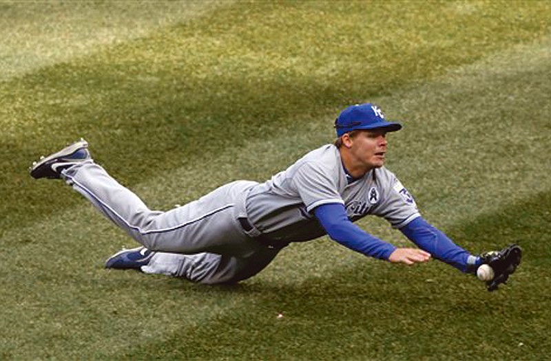 Royals second baseman Chris Getz is unable to catch a shallow fly ball off the bat of White Sox's Alexei Ramirez during Monday's season opener in Chicago. The Royals lost 1-0.