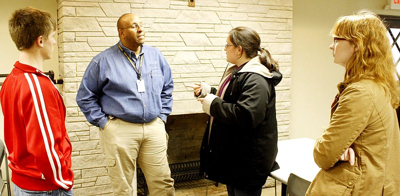 Lt. Andre Cook, chief of detectives at the Fulton Police Department, chats with students after he was the featured speaker Thursday at the Alumni Speakers Series at William Woods University in Fulton.