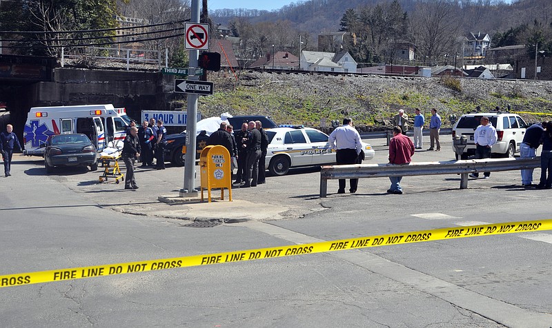 Law enforcement officers and emergency service personnel converge on the scene Wednesday of the shooting in downtown Williamson, W.Va., where Sheriff Eugene Crum was shot and killed at point blank range. 