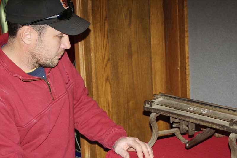 Mark Brooks of Auxvasse, a sheet metal worker, checks out antique tools used by sheet metal workers. The tools were included in a display prepared for "The Way We Worked" Smithsonian exhibit at the National Churchill Memorial in 2012. The exhibit has won a statewide humanities award for the exhibition.