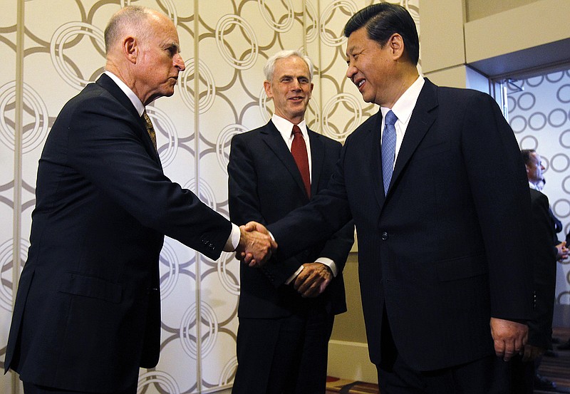  In this Feb. 17, 2012 file photo, Chinese Vice President Xi Jinping is greeted by California Governor Jerry Brown as Commerce Secretary John Bryson looks on at the JW Marriott hotel before attending the US-China Economy and Trade Cooperation Forum in Los Angeles. 