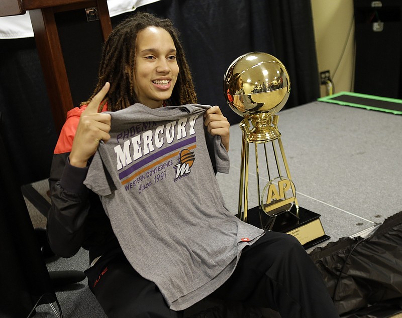 Baylor's Brittney Griner holds up Phoenix Mercury shirt as she poses next to The Associated Press College Basketball Player of the Year trophy during a news conference at the Women's Final Four of the NCAA college basketball tournament, Saturday, April 6, 2013, in New Orleans. 