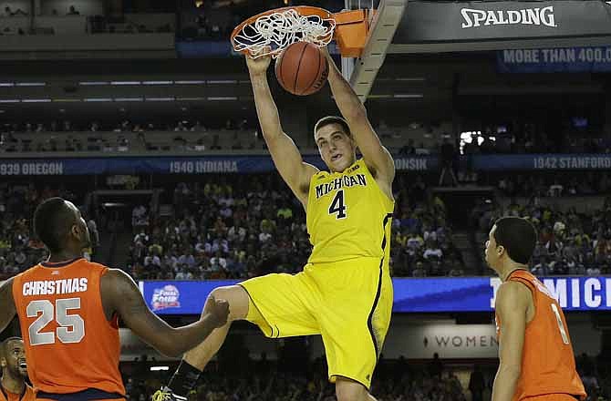 Michigan's Mitch McGary dunks the ball against Syracuse during the second half of the NCAA Final Four tournament college basketball semifinal game Saturday, April 6, 2013, in Atlanta.