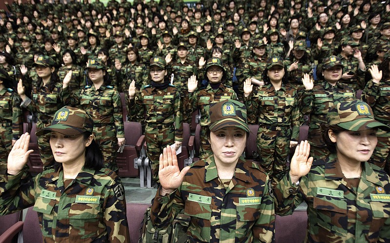 South Korean army reservists raise their hands to adopt a resolution against North Korea during a rehearsal for their Foundation Day ceremony at a gymnasium in Seoul, South Korea, Friday, April 5, 2013. About 1,000 reservists denounce North Korean for their escalating threat for war. North Korea has been railing against U.S.-South Korean military exercises that began in March and are to continue until the end of this month. The allies insist the exercises in South Korea are routine, but the North calls them rehearsals for an invasion and says it needs nuclear weapons to defend itself. 