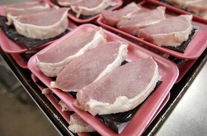 This March 3, 2011 file photo shows boneless pork loins waiting to be packaged at a local Dahl's grocery store in Des Moines, Iowa. The American meat industry is rolling out a refresh of the often confusing 40-year-old system used for naming the various cuts of beef, pork, lamb and veal.