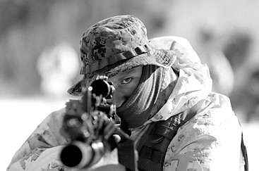 An unidentified U.S. Marine from 3-Marine Expeditionary Force 1st Battalion faims his gun during a February  joint military winter exercise with their South Korean counterparts in Pyeongchang, east of Seoul, South Korea. 