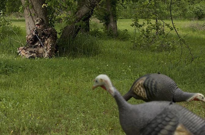 A hunter looks over his turkey hunting decoys as the start of turkey season nears. 