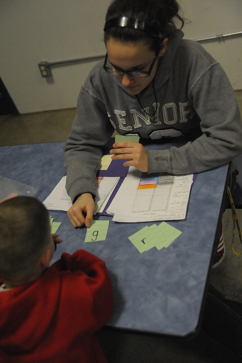  Cadet Teacher Faith Shull works one-on-one with preschoolers like Landon Kaiser to reinforce lessons, including letter recognition. Michelle Brooks/Democrat staff