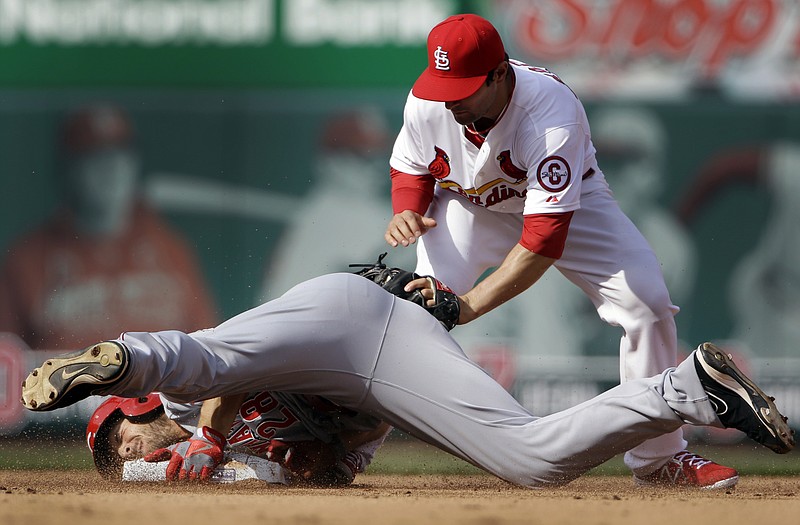 Chris Heisey of the Reds is safe at second for a double ahead of the tag from Cardinals shortstop Pete Kozma during the fourth inning of Monday afternoon's game at Busch Stadium.