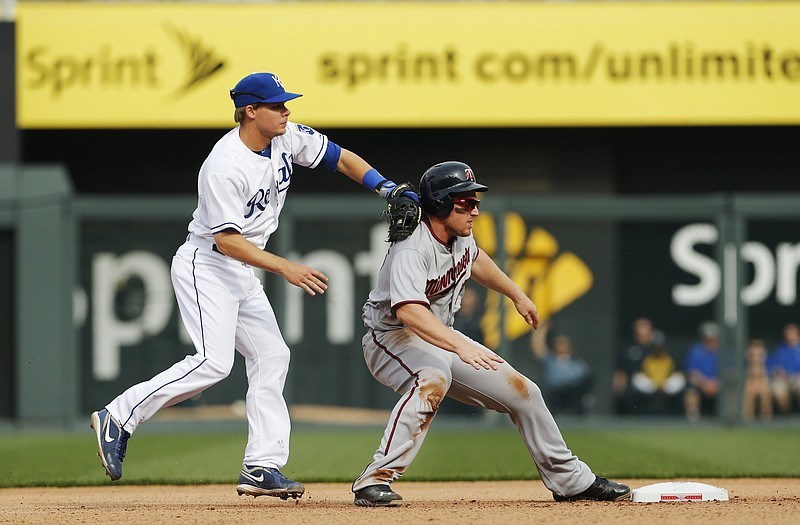 Royals second baseman Chris Getz tags out Chris Parmelee of the Twins during the seventh inning of Monday afternoon's game at Kauffman Stadium.