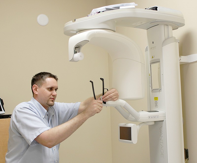 Daniel Giddens of St. Louis installs new Vantage X-ray equipment Tuesday for Henry Schein Equipment Services of St. Louis at the new Fulton dental clinic to open in May.