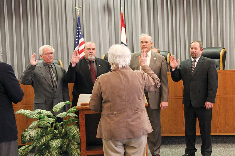 Returning Fulton councilmen are all sworn in by City Clerk Carolyn Laswell before the council meeting Tuesday. From left: Richard Vaughn, Rick Shiverdecker, Wayne Chailland and Lowe Cannell. Vaughn, Chailland and Cannell ran unopposed, while Shiverdecker defeated opponent Kathy Segerson. Also sworn in was City Prosecutor Casey Clevenger, who also sought re-election unopposed.